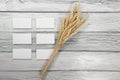 Wheat Ears on Wooden Table with blank business cards. Sheaf of Wheat over Wood Background. Harvest concept. Royalty Free Stock Photo