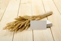 Wheat Ears on Wooden Table with blank business cards. Sheaf of Wheat over Wood Background. Harvest concept. Royalty Free Stock Photo