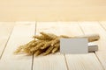 Wheat Ears on Wooden Table with blank business cards. Sheaf of Wheat over Wood Background. Harvest concept. Royalty Free Stock Photo