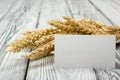 Wheat Ears on Wooden Table with blank business cards. Sheaf of Wheat over Wood Background. Harvest concept. Royalty Free Stock Photo