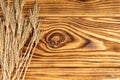 Wheat Ears on the Wooden Table. Sheaf of Wheat over Wood Background. Royalty Free Stock Photo