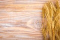 Wheat Ears on the Wooden Table. Sheaf of Wheat over Wood Background. Harvest concept Royalty Free Stock Photo