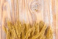 Wheat Ears on the Wooden Table. Sheaf of Wheat over Wood Background. Harvest concept Royalty Free Stock Photo