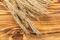 Wheat Ears on the Wooden Table. Sheaf of Wheat over Wood Background. Royalty Free Stock Photo