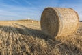 Wheat field after harvest with straw bales at sunset Royalty Free Stock Photo