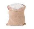 Wheat flour in burlap sack bag on white background