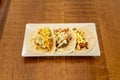 Wheat flour tortilla tacos with assorted fillings, grated cheese, pulled meat, sweet corn on wooden table Royalty Free Stock Photo