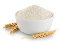 wheat flour in a white ceramic bowl and spikelets isolated on a white background Royalty Free Stock Photo