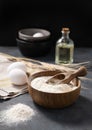 Wheat flour in a wooden bowl with a scoop on a dark blue background with eggs, oil and dry branches wheat. Organic ingredients for Royalty Free Stock Photo