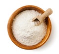 Wheat flour in a wooden bowl with a scoop on a white background. Isolated, top view Royalty Free Stock Photo