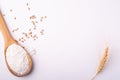 Wheat flour in wooden spoon spatula near with heap of grains and with ear of wheat, top view, flat lay Royalty Free Stock Photo