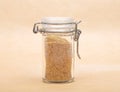 Wheat germs in closed jar on brown background Royalty Free Stock Photo