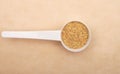 Wheat germs in measuring spoon on brown background Royalty Free Stock Photo