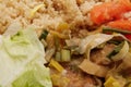 Wheat gluten on leek with couscous on a table