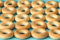 Wheat golden bagels on a blue background.