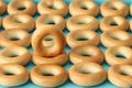 Wheat golden bagels on a blue background.