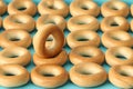 Wheat golden bagels on a blue background.