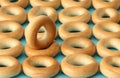 Wheat golden bagels on a blue background.