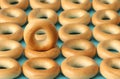 Wheat golden bagels on a blue background.