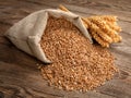 Wheat grain in the bag and spikelets at the old board