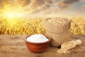 Wheat grains and flour on field background Royalty Free Stock Photo