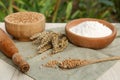 Wheat grains, flour and spikelets on table outdoors Royalty Free Stock Photo