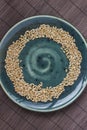 Wheat grains on a green ceramic plate. Brown background. Top vie Royalty Free Stock Photo