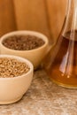 Wheat grains in wooden bowl and oil in decanter