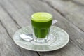 Wheat grass juice natural drink with fresh wheatgrass in glass on old wooden table background. Organic healthy organic green detox Royalty Free Stock Photo
