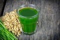 Wheat grass juice on wood background Royalty Free Stock Photo