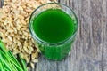 Wheat grass juice on wood background Royalty Free Stock Photo