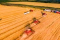 Wheat harvesting process. red combines work in the field. Royalty Free Stock Photo