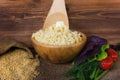 Wheat grits in a wooden bowl. Royalty Free Stock Photo