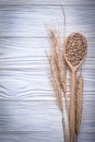 Wheat-rye ears wooden spoon corn on wood board