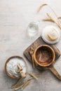 Wheat rye spikelets and flour in wooden bowl and spoon Royalty Free Stock Photo