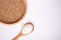 Wheat seeds grains in wooden bowl near with flour in spoon spatula, top view, flat lay, isolated on white background Royalty Free Stock Photo