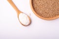 Wheat seeds grains in wooden bowl near with flour in spoon spatula, top view, flat lay, isolated on white background Royalty Free Stock Photo