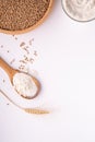 Wheat seeds grains in wooden bowl, wheat flour in glass bowl, near with flour in spoon spatula with heap of grains, ear of wheat Royalty Free Stock Photo