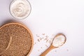 Wheat seeds grains in wooden bowl, wheat flour in glass bowl, near with flour in spoon spatula with heap of grains, ear of wheat Royalty Free Stock Photo