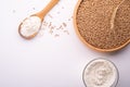 Wheat seeds grains in wooden bowl, wheat flour in glass bowl, near with flour in spoon spatula with heap of grains, ear of wheat Royalty Free Stock Photo