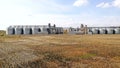 Wheat storage elevator. silver silos on agro manufacturing plant for processing drying cleaning and storage of Royalty Free Stock Photo