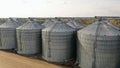 Wheat storage elevator. silver silos on agro manufacturing plant for processing drying cleaning and storage of
