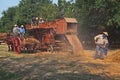 Wheat threshing with ancient equipment during the country fair Royalty Free Stock Photo