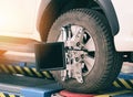 Wheel alignment equipment car mechanic installing sensor suspension adjustment auto sets on tire diagnostics in the garage car Royalty Free Stock Photo