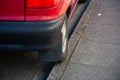 the wheel of a badly parked car parked on a curb