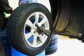 Wheel balancing or repair and change car tire at auto service garage or workshop by mechanic Royalty Free Stock Photo