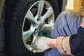 Wheel balancing or repair and change car tire at auto service garage or workshop by mechanic Royalty Free Stock Photo