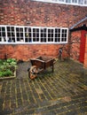 Wheel barrow in museum garden Royalty Free Stock Photo