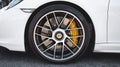 Wheel, brake disc, yellow caliper on a Porsche car. Side view