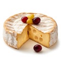 A wheel of brie cheese with a segment removed, garnished with grapes, with a creamy, holey texture and white rind